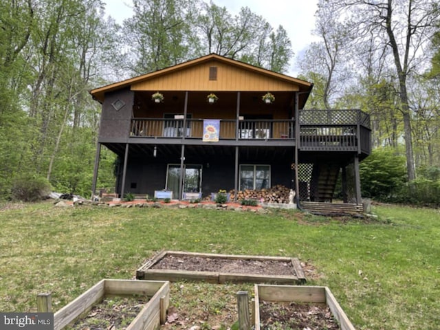 359 Old Linden Rd, Linden, VA 22642 - rear view of house featuring a vegetable garden, a lawn, and a deck