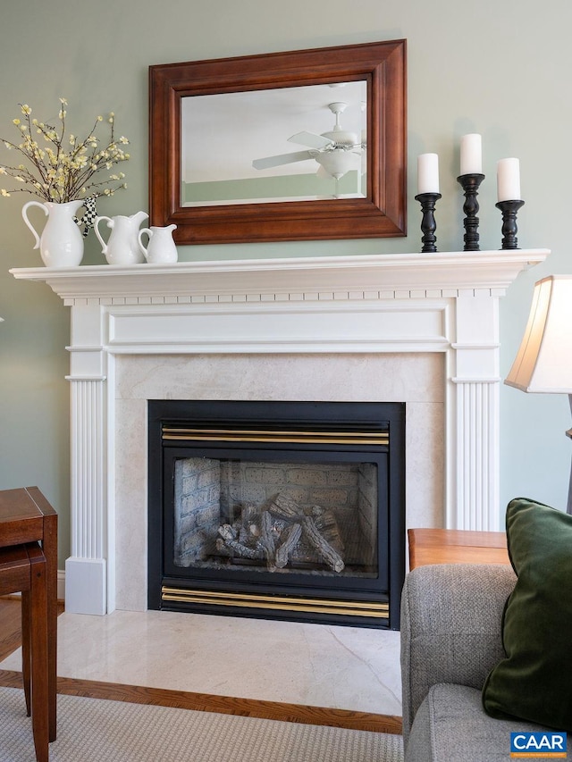 detailed view of a fireplace and a ceiling fan
