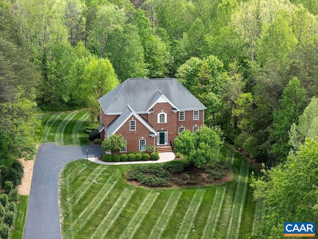 view of subject property with a forest