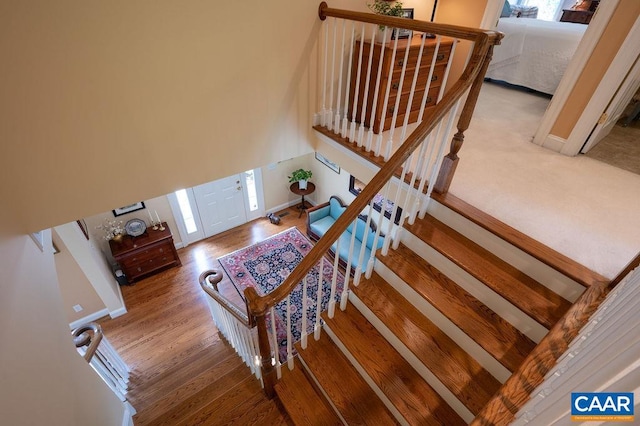 stairway featuring wood finished floors and baseboards