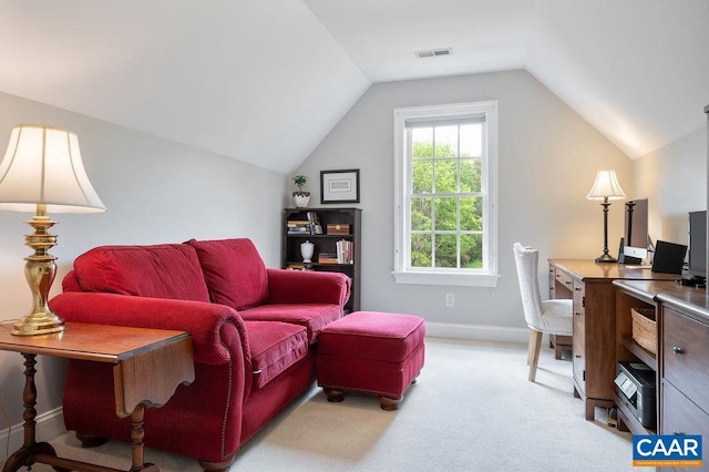 home office featuring light carpet, vaulted ceiling, and baseboards