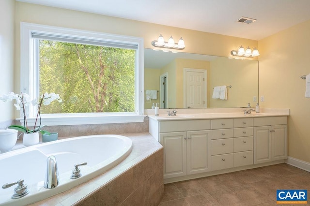 bathroom featuring double vanity, a bath, and tile patterned flooring