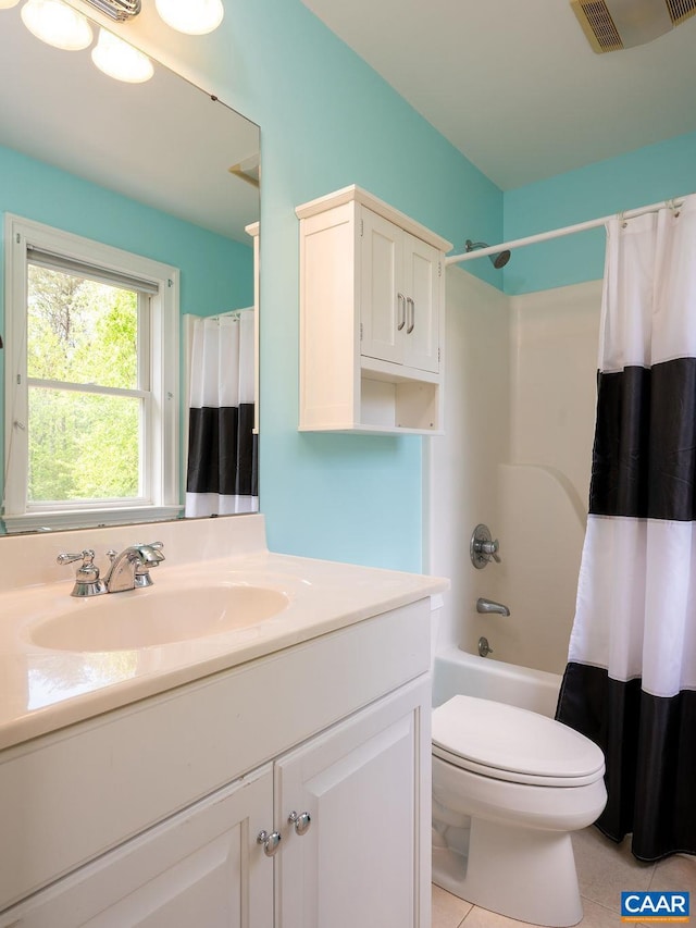 full bath featuring vanity, tile patterned floors, toilet, and shower / tub combo