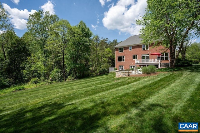 view of grassy yard featuring a deck