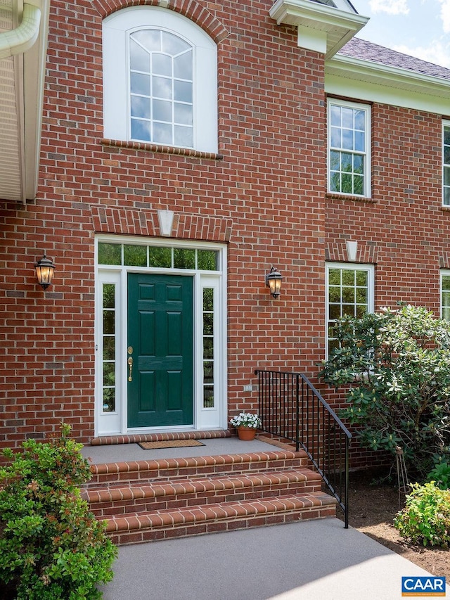 doorway to property with brick siding