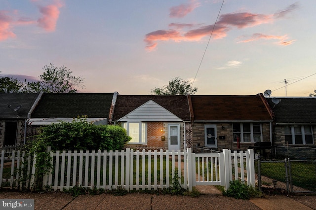 view of front facade with a fenced front yard and stone siding