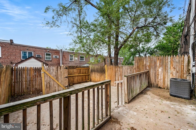 exterior space with central AC unit and fence