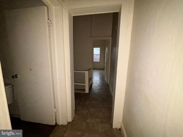 hall featuring baseboards