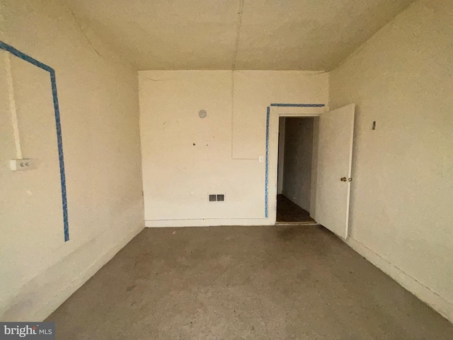 spare room featuring unfinished concrete floors