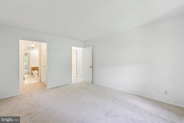 unfurnished bedroom with light carpet and baseboards