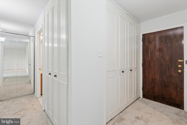 hallway featuring light colored carpet