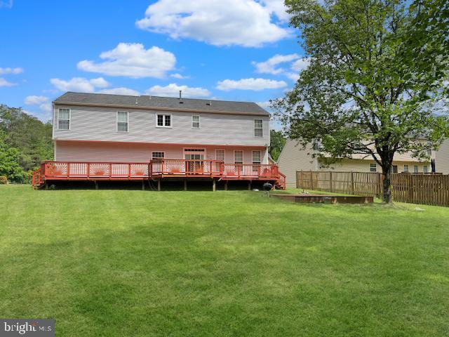 rear view of property featuring a deck