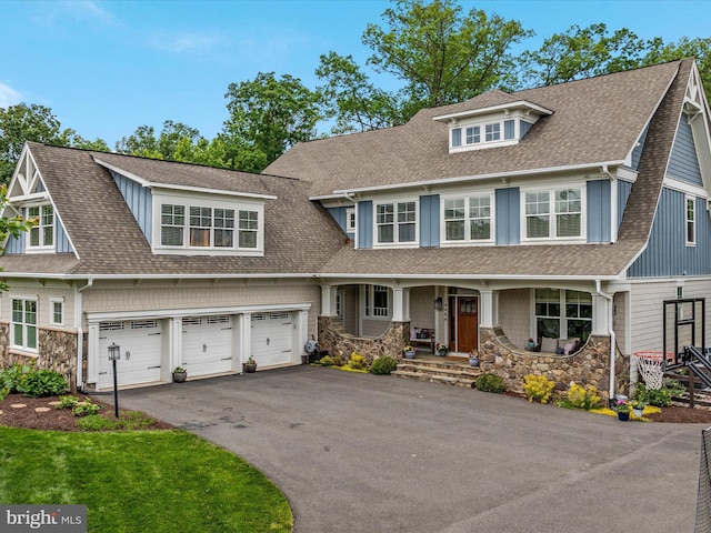 14484 Bluff Point Ct, Gainesville, VA 20155 - shingle-style home featuring a porch, roof with shingles, asphalt driveway, a garage, and stone siding