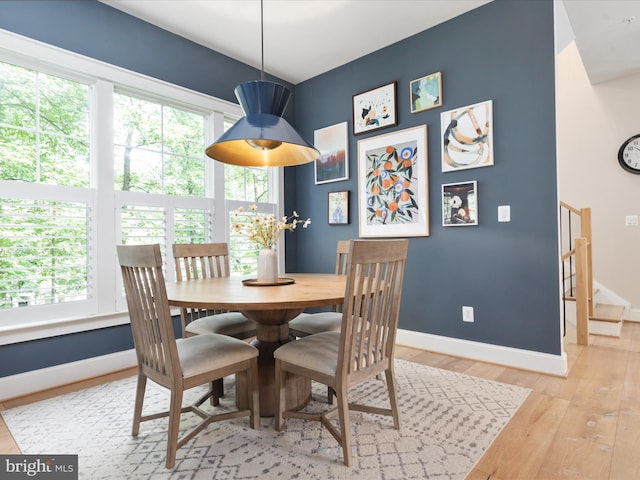 14484 Bluff Point Ct, Gainesville, VA 20155 - dining area featuring baseboards, light wood finished floors, and stairway