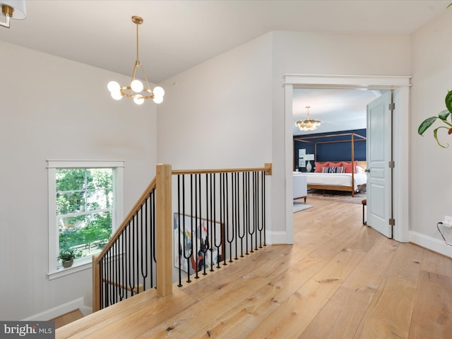 14484 Bluff Point Ct, Gainesville, VA 20155 - corridor with a chandelier, an upstairs landing, hardwood / wood-style flooring, and baseboards