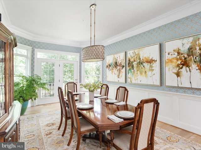 14484 Bluff Point Ct, Gainesville, VA 20155 - dining area with wallpapered walls, crown molding, and light wood-style flooring