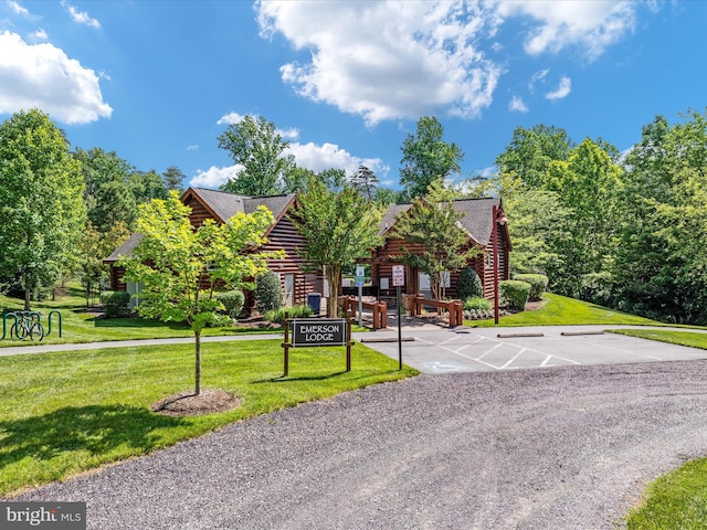 14484 Bluff Point Ct, Gainesville, VA 20155 - cabin with log siding, a front lawn, and a shingled roof