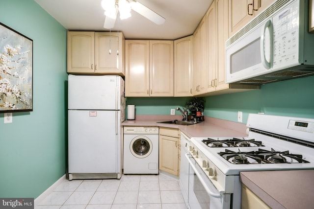 5101 River Rd Unit 811, Bethesda, MD 20816 - kitchen featuring white appliances, washer / clothes dryer, a sink, light countertops, and light tile patterned flooring
