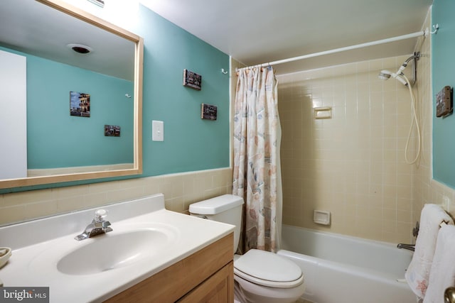5101 River Rd Unit 811, Bethesda, MD 20816 - bathroom featuring vanity, toilet, tile walls, shower / bath combo with shower curtain, and wainscoting