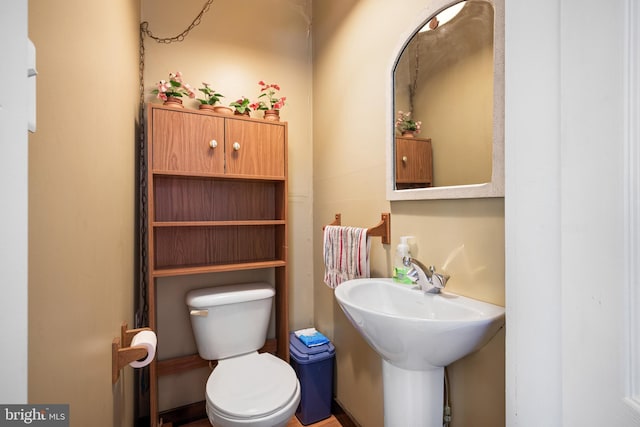 bathroom with toilet and a sink