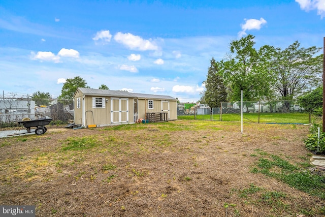 exterior space featuring a fenced backyard, an outdoor structure, and a storage shed