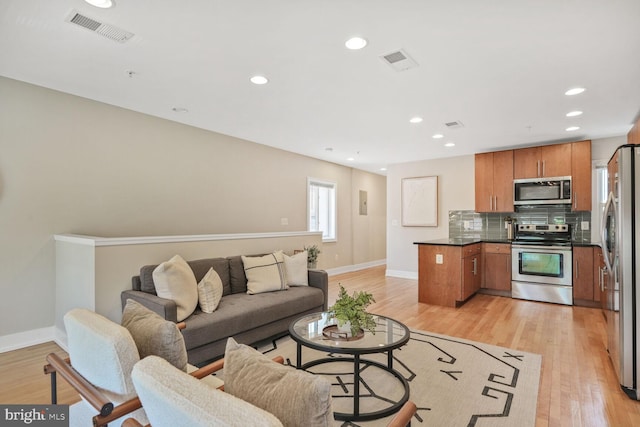 2515 17th St NW Unit 5, Washington, DC 20009 - living room featuring baseboards, light wood-style flooring, and recessed lighting