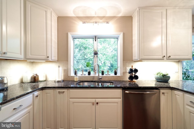 kitchen with a sink, white cabinetry, a wealth of natural light, and dishwasher