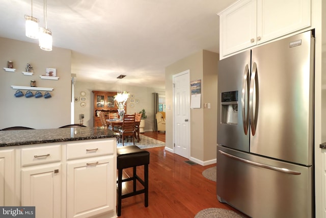 kitchen with decorative light fixtures, baseboards, white cabinetry, dark wood-style floors, and stainless steel fridge with ice dispenser