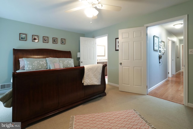 carpeted bedroom with baseboards, visible vents, and a ceiling fan
