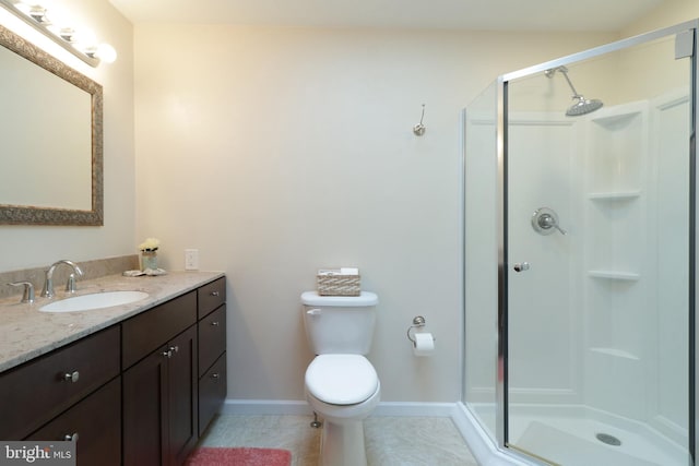 full bath with toilet, vanity, tile patterned floors, a shower stall, and baseboards