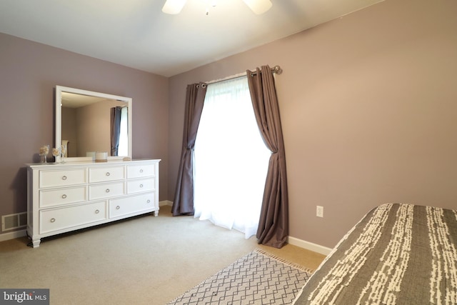bedroom featuring light colored carpet, baseboards, a ceiling fan, and visible vents