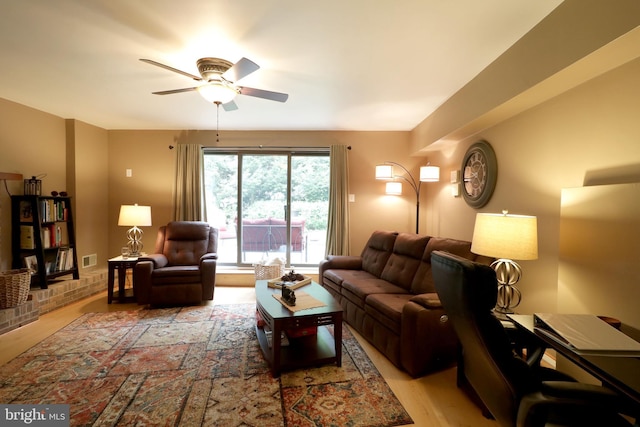 living room featuring light wood-type flooring and ceiling fan