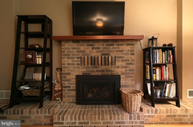 interior details with visible vents and a brick fireplace