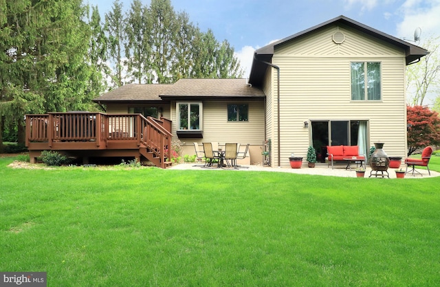 back of house featuring a lawn, a deck, a patio, and an outdoor hangout area