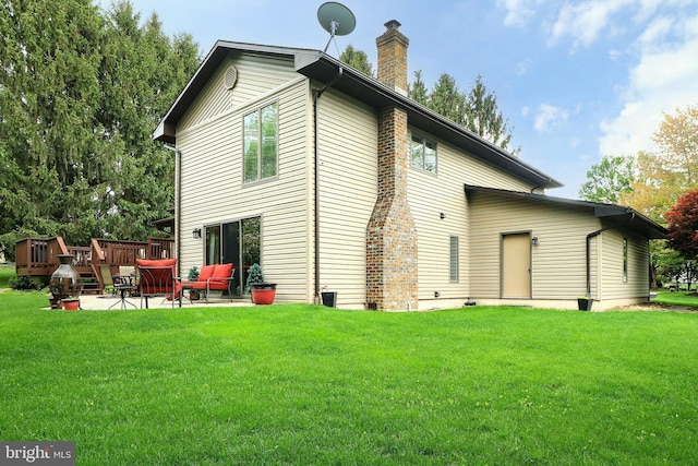 rear view of house featuring a yard, a patio area, outdoor lounge area, and a chimney