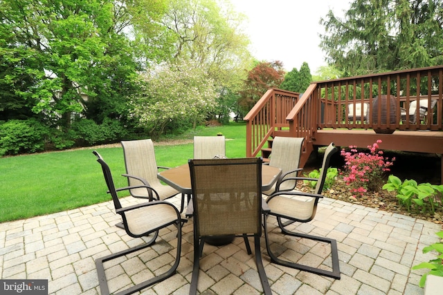 view of patio featuring stairs, outdoor dining area, and a deck