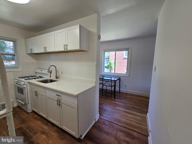 105 S Iris St, Alexandria, VA 22304 - kitchen featuring white range with gas stovetop, a sink, dark wood finished floors, and light countertops