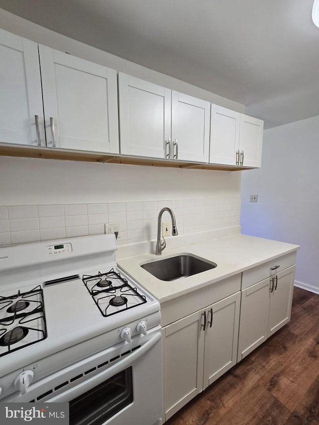 105 S Iris St, Alexandria, VA 22304 - kitchen with white gas stove, a sink, dark wood-style floors, and light countertops