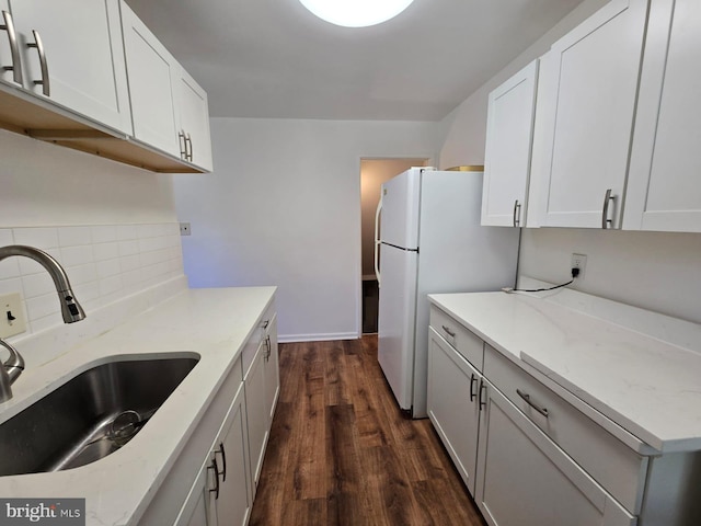 105 S Iris St, Alexandria, VA 22304 - kitchen featuring a sink, dark wood-type flooring, backsplash, light stone countertops, and freestanding refrigerator