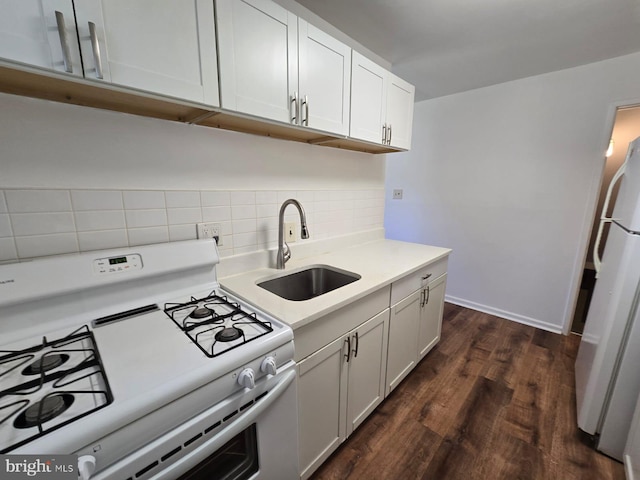 105 S Iris St, Alexandria, VA 22304 - kitchen featuring white appliances, a sink, backsplash, light countertops, and dark wood-type flooring