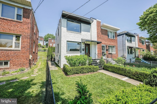 236 Nicholson St NE, Washington, DC 20011 - view of front of home with a front yard, brick siding, and fence