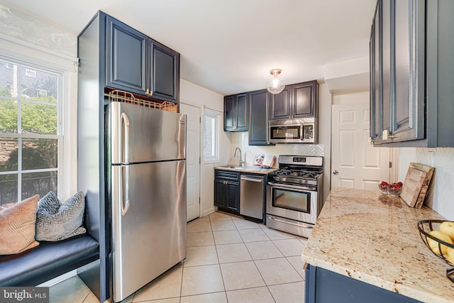 236 Nicholson St NE, Washington, DC 20011 - kitchen with light tile patterned floors, a wealth of natural light, stainless steel appliances, and a sink