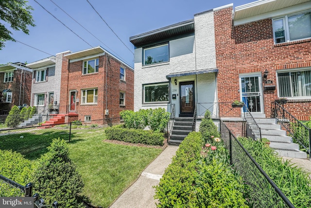236 Nicholson St NE, Washington, DC 20011 - view of property featuring brick siding, fence, and a front yard
