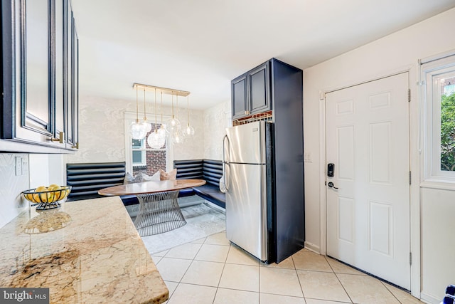 236 Nicholson St NE, Washington, DC 20011 - kitchen featuring freestanding refrigerator, light tile patterned flooring, and hanging light fixtures