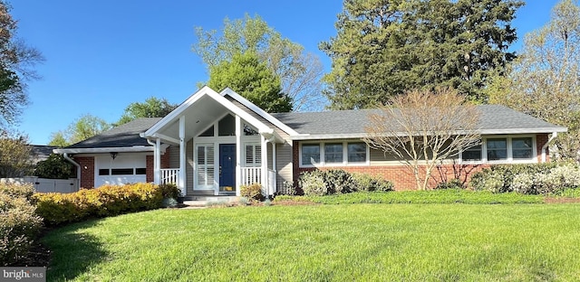 ranch-style home featuring brick siding, a garage, a front yard, and a shingled roof