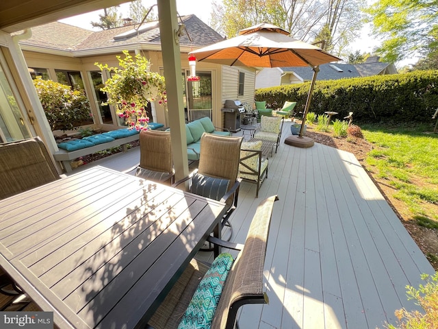 wooden deck with an outdoor hangout area, outdoor dining area, and area for grilling