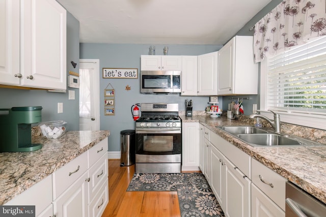 208 Veterans Ave, West Berlin, NJ 08091 - kitchen with appliances with stainless steel finishes, a sink, light wood-style floors, white cabinets, and light countertops