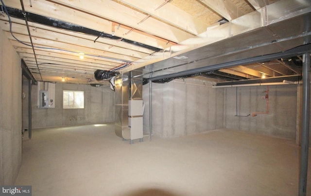 basement with heating unit and electric panel