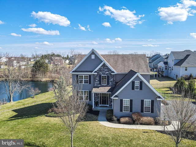 33 Docwill Dr, Barto, PA 19504 - traditional-style house with fence, stone siding, a residential view, a front lawn, and a water view