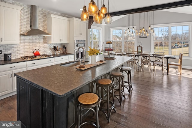 33 Docwill Dr, Barto, PA 19504 - kitchen with an inviting chandelier, a sink, wall chimney range hood, lofted ceiling with beams, and appliances with stainless steel finishes